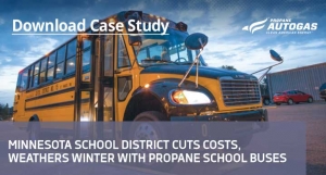 A school bus with the words " school district cuts costs, winter with propane school ".