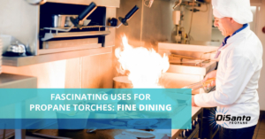 A kitchen with fire burning in the middle of it.