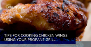 A close up of chicken wings on top of a grill.