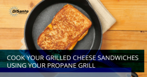 A grilled cheese sandwich in a pan on the stove.
