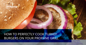 A turkey burger with onions and tomatoes on it.