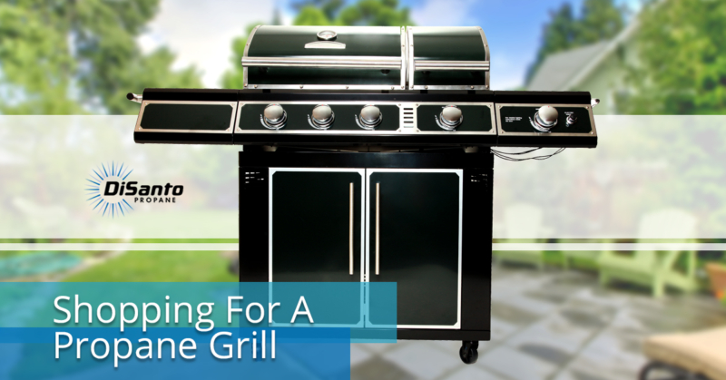 A black and silver grill sitting on top of a table.