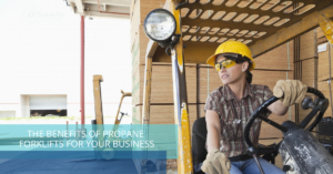 A woman in hard hat sitting on top of a wooden platform.