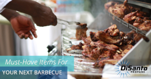 A person is cooking meat on the grill.