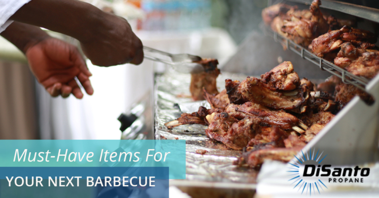 A person is cooking meat on the grill.