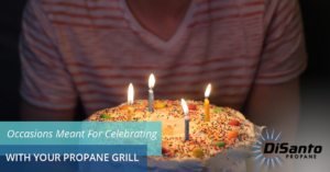 A person sitting in front of a cake with lit candles.