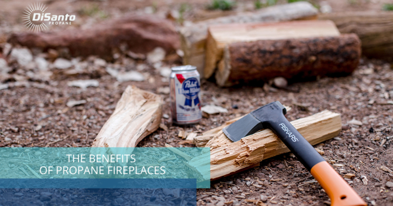 A can of beer and some wood on the ground.
