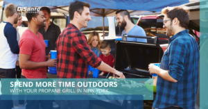 A man is playing an outdoor grill while people watch.