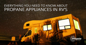 A yellow rv parked in the dark at night.