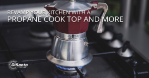 A red and silver coffee pot on top of a stove.