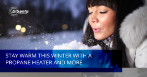 A woman is blowing snow from her hands.