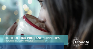 A woman drinking from a cup with the words " your propane suppliers."