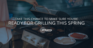 A person is cooking on an outdoor grill.