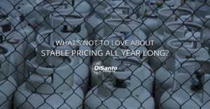 A fence with many gas cylinders behind it.