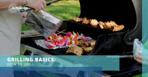 A person grilling food on top of an outdoor grill.