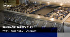 A gas stove with the lid open and the oven closed.