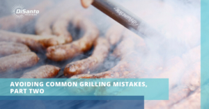 A grill with sausage being cooked on it.