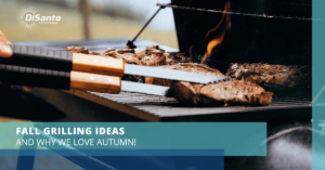 A bbq with some meat on it and two knives