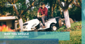 A man sitting on top of a lawn mower.
